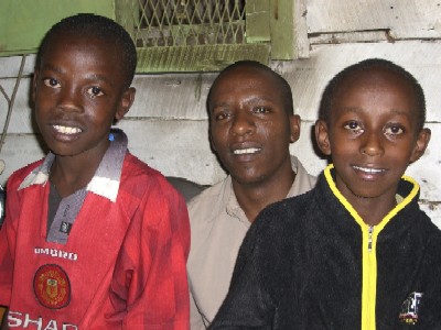 Ngugi Mwangi, co-founder of Zingaro Percussion Self-Help Group, with son (right) and another boy in the group